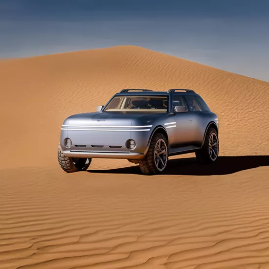 Driver side 3/4 view of Genesis X Gran Equator Concept parked on dessert sand dune