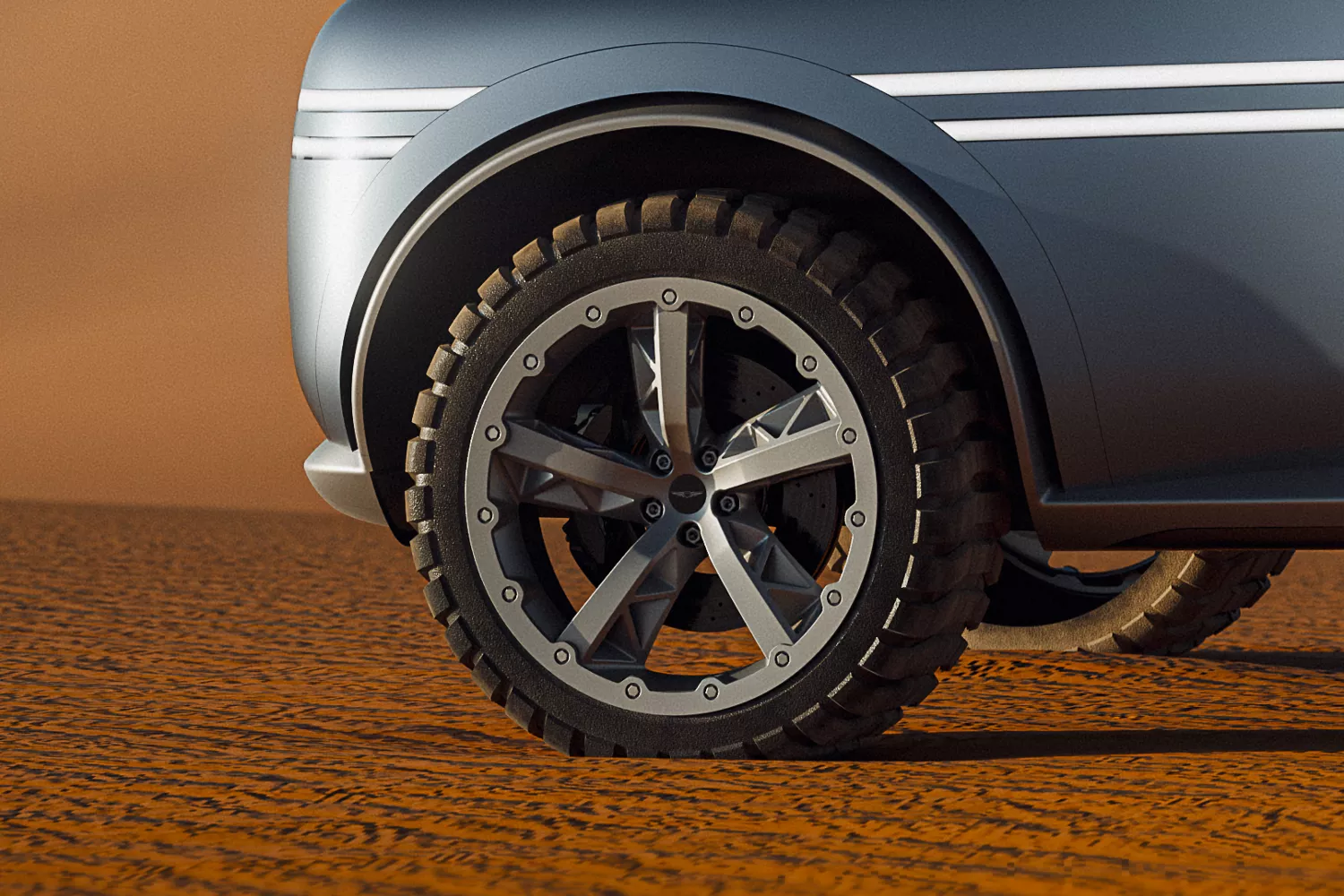 Closeup of Genesis X Gran Equator Concept wheel and tire parked on dessert sand