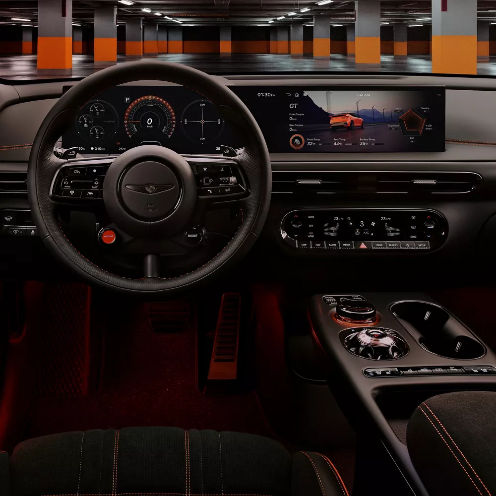 Interior close up steering wheel and digital dashboard on 2027 Genesis GV60 Magma