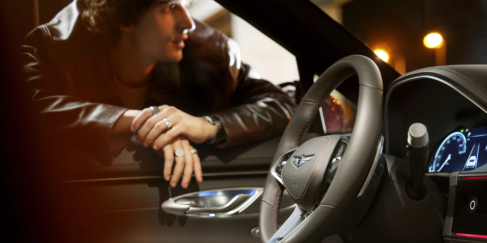 Image of a man leaning through the driver's side window