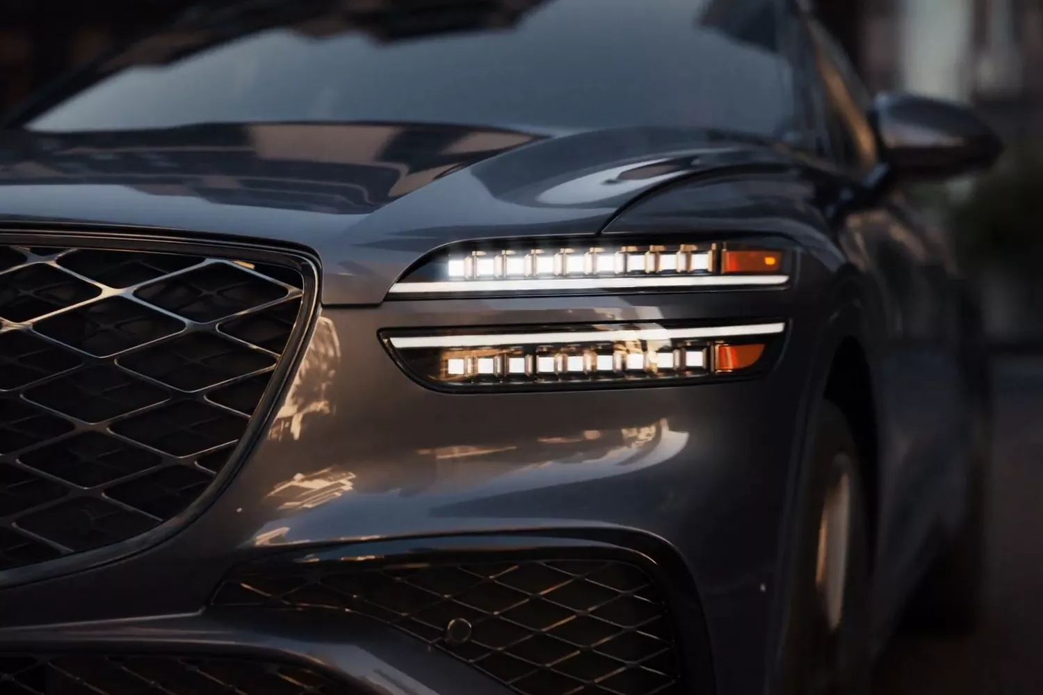 Close-up of 2026 Genesis GV70 front grille and signature two-line LED headlights