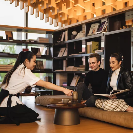 Guests looking at a menu at the Genesis House Tea Pavilion.