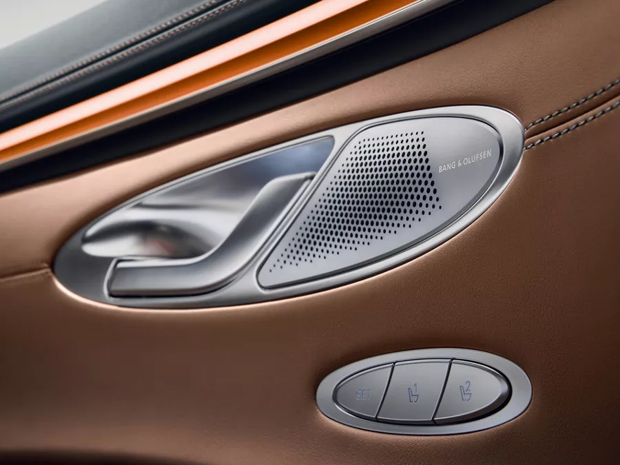 Close up of Genesis GV70's interior door handle and Bang & Olufsen speaker