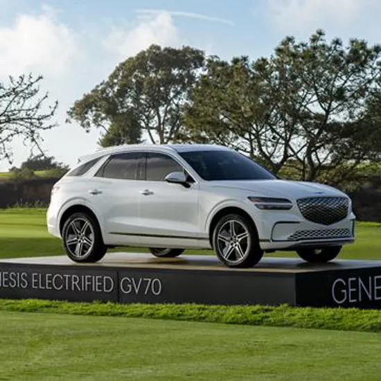 Front passenger side view of Genesis Electrified GV70 in white on display on the green at Genesis Invitational