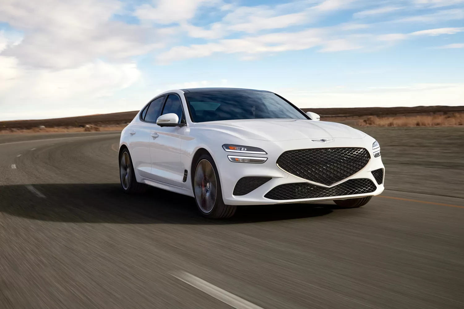 "Handling & Responsiveness" component with close up of Genesis G70 in Alta White on empty highway