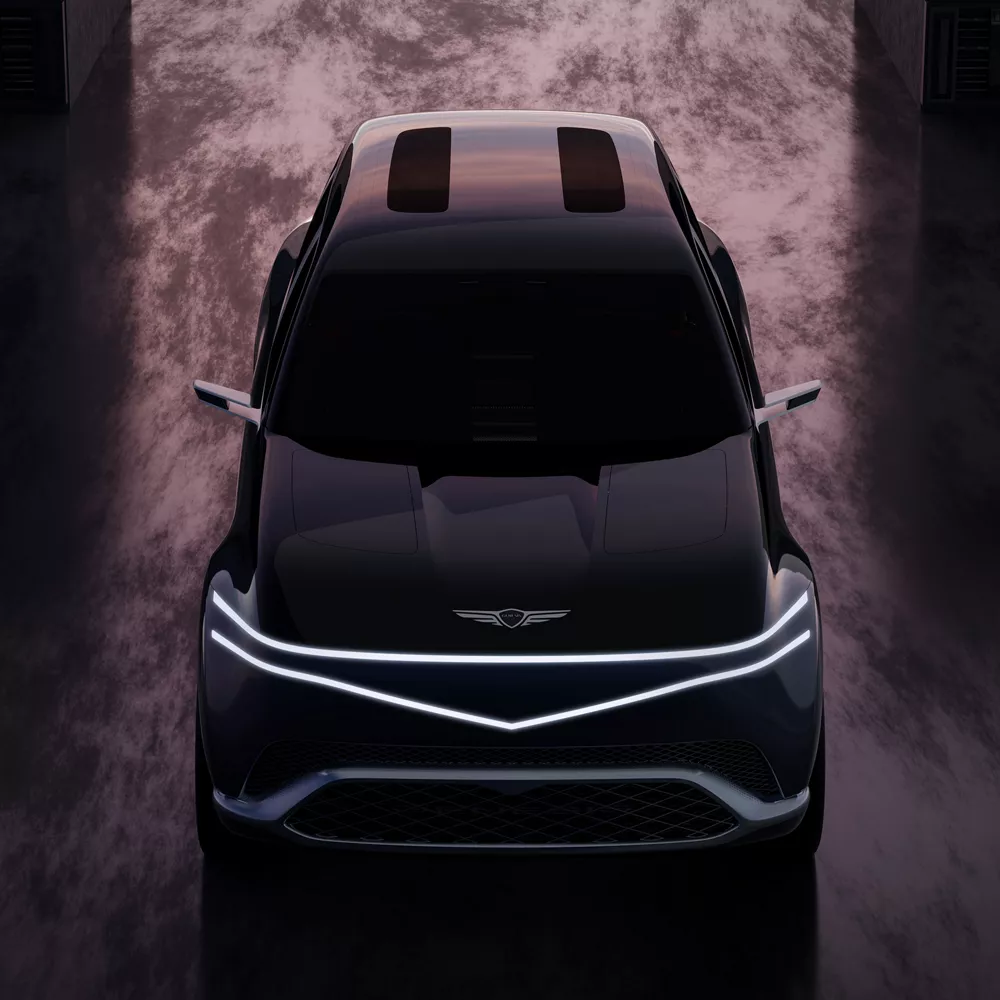 Front top-down view of Genesis Neolun Concept vehicle with sunset reflecting on wet pavement