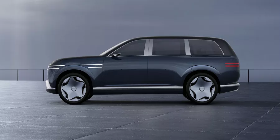 Driver side profile view of Genesis Neolun Concept vehicle against a gray wall