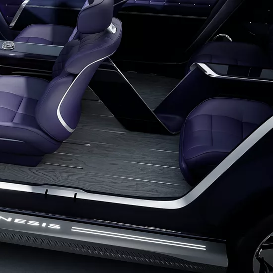 Genesis Neolun Concept vehicle interior with front/rear seats, open doors, Genesis logo on frame.