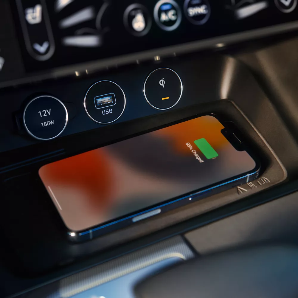 Interior closeup of phone on wireless charging station inside 2027 Genesis G70