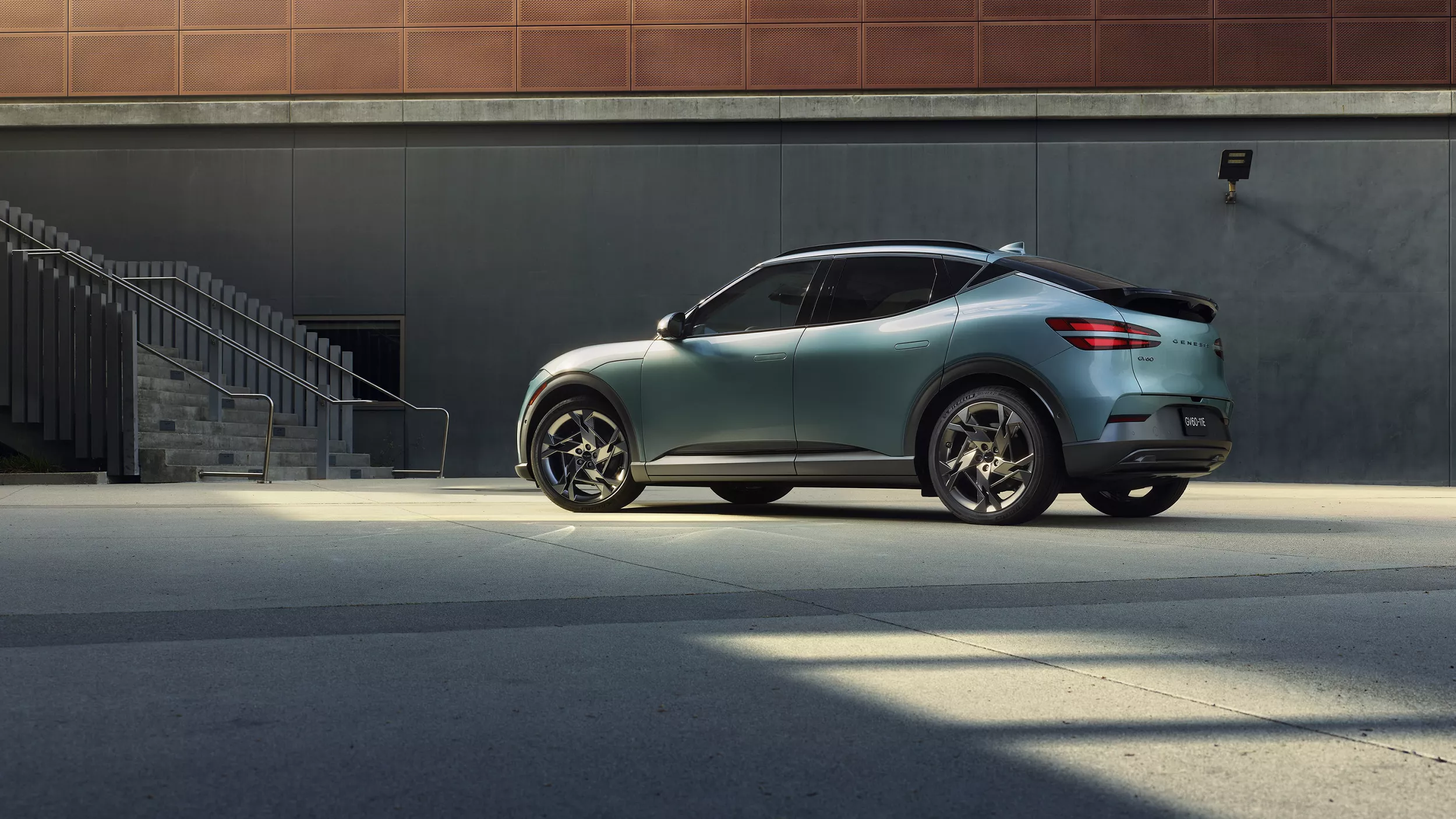 Driver's side view of Genesis GV60 in Hanuama Mint