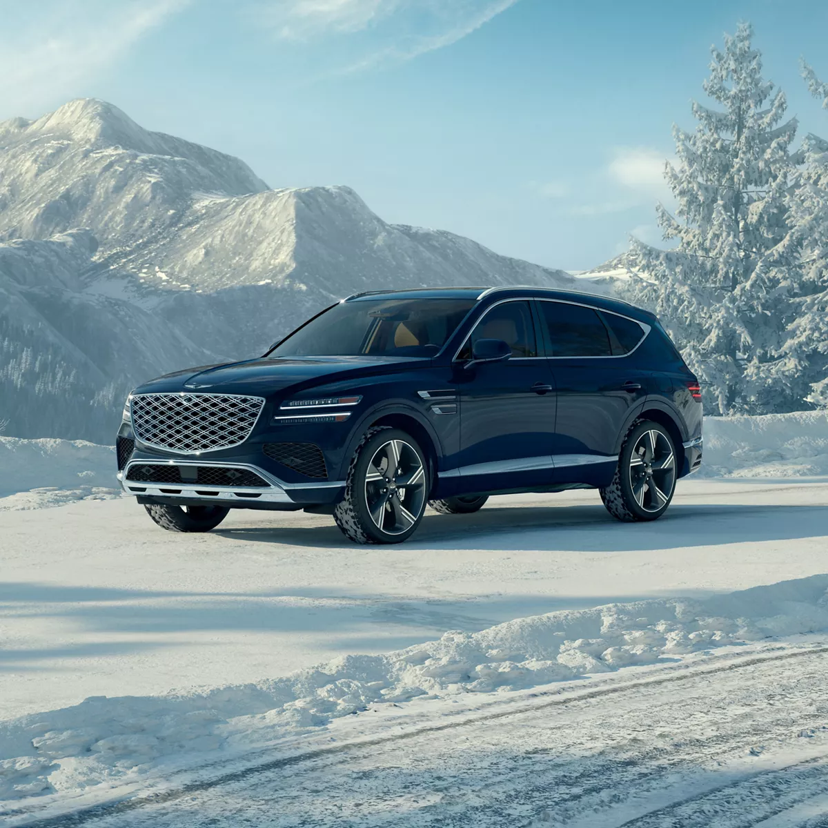 3/4 front driver side view of Genesis GV80 in Capri Blue parked in snowy mountain scenery