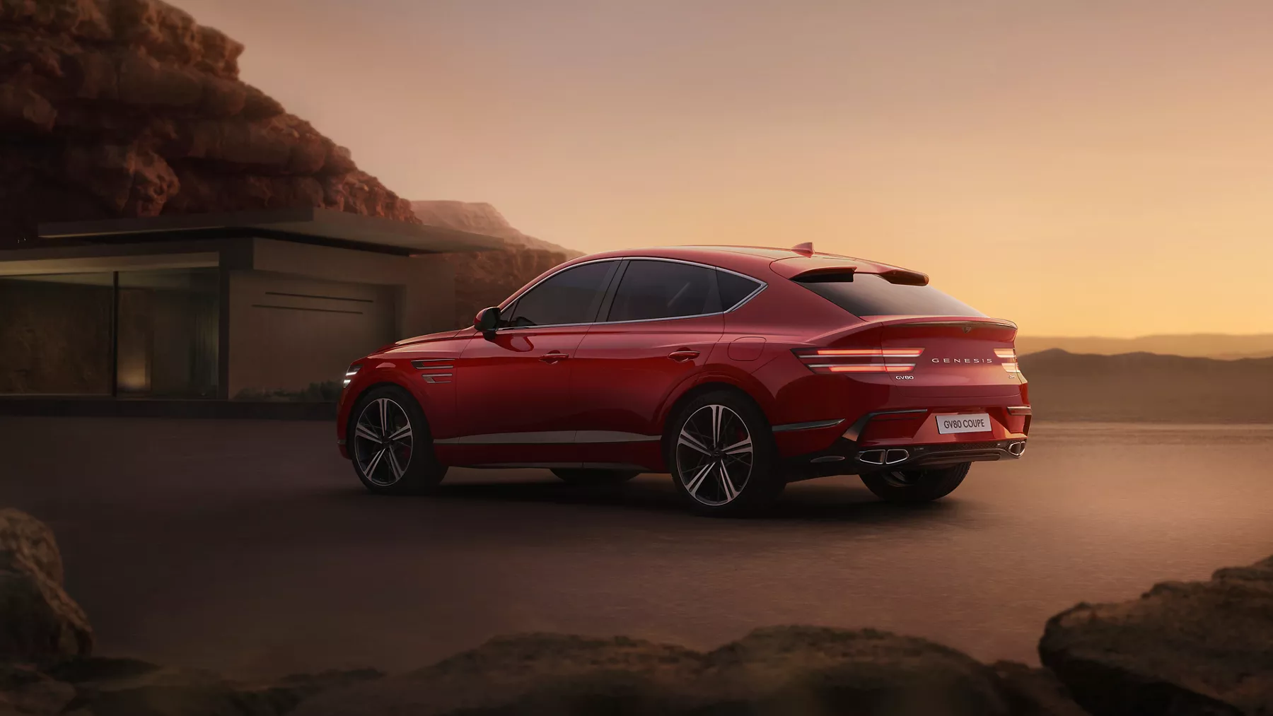 Red Genesis GV80 Coupe in front of a home at sunset