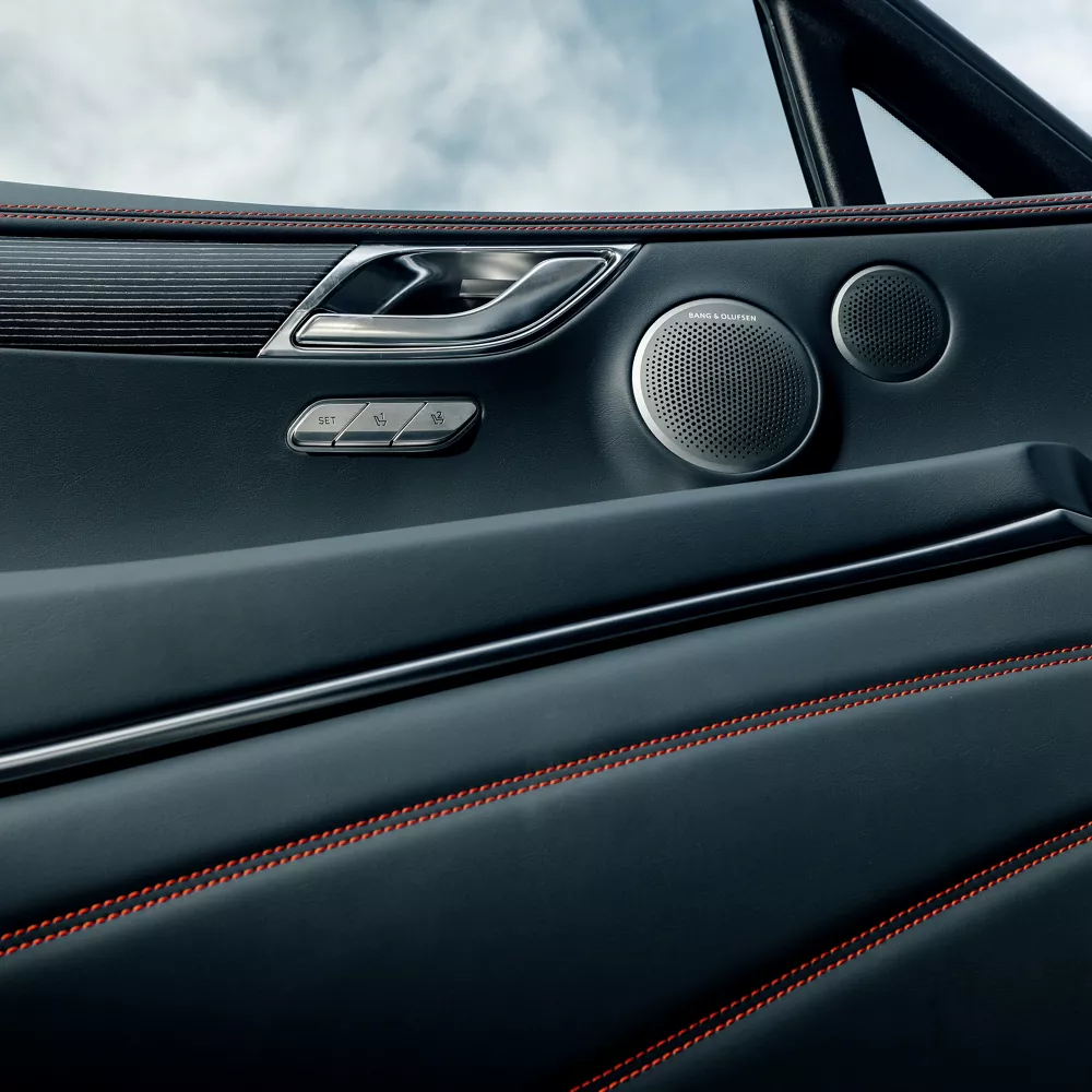 Interior close up of driver side door panel in Ultramarine Blue, inside Genesis GV80 Coupe