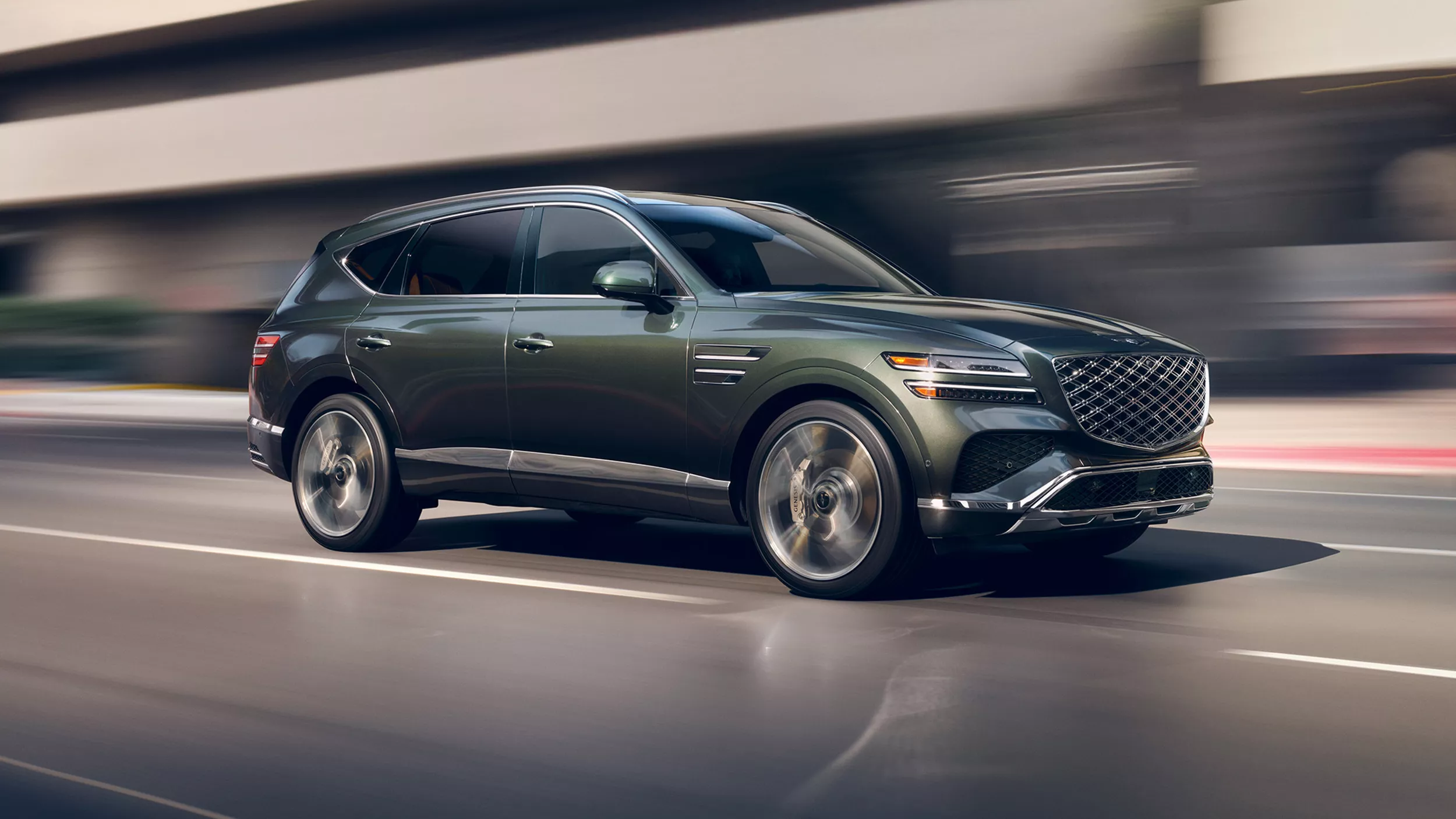 2026 Genesis G90, G80, GV80, and GV80 Coupe Prestige Black vehicles driving along beach shoreline