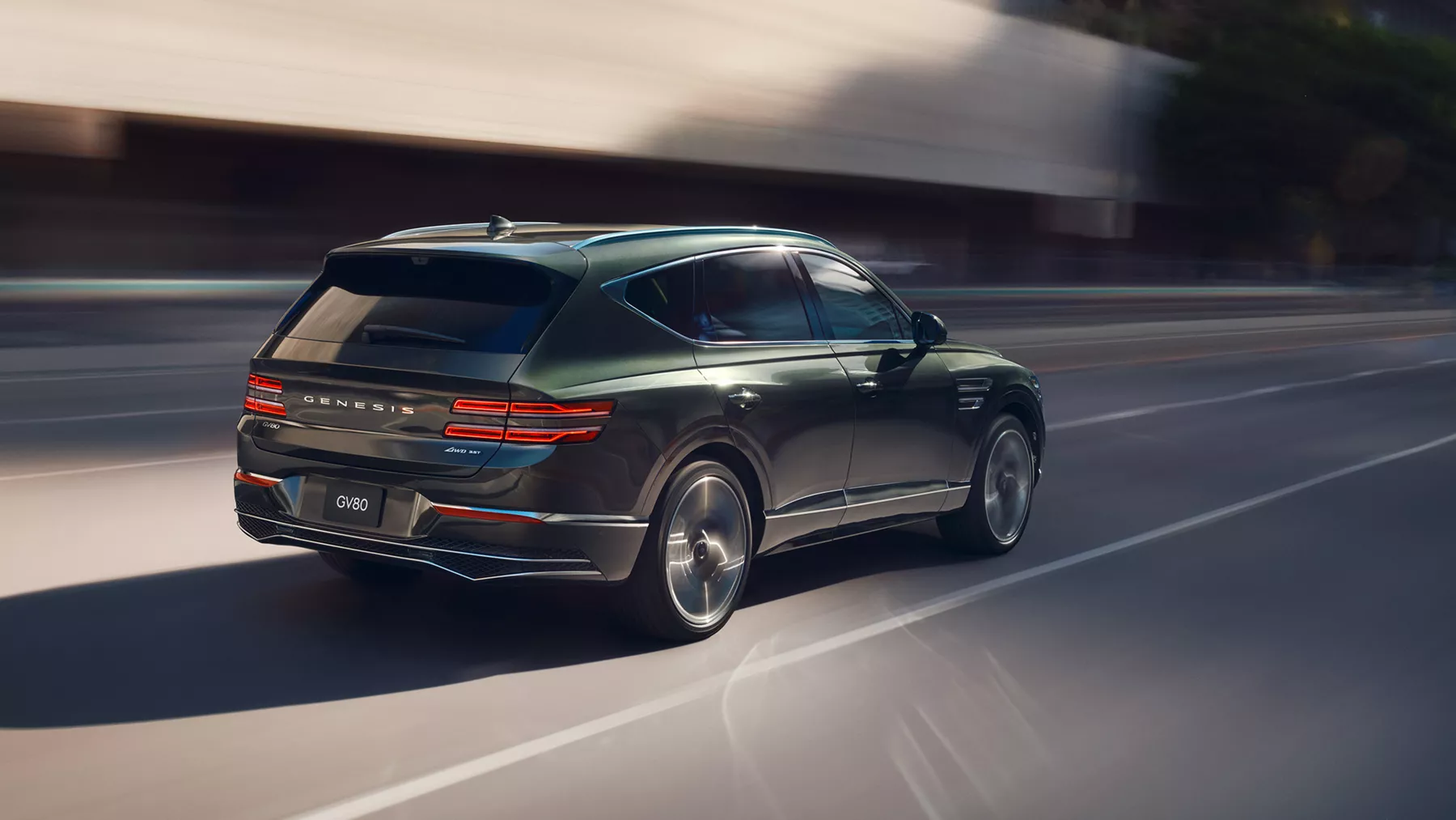 Motion blurred 3/4 rear passenger view of Genesis GV80 in Storr Green driving in urban environment