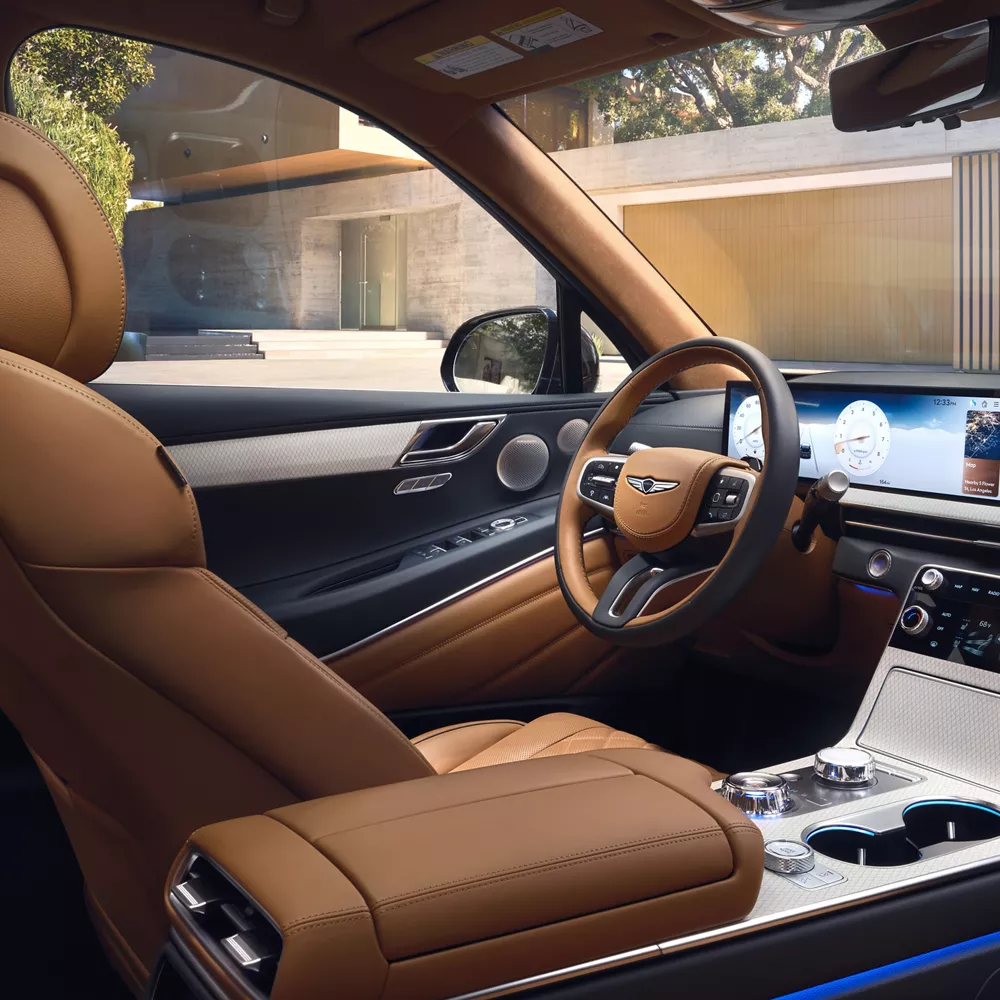 Genesis GV80 interior with tan leather seats, highlighting wide OLED infotainment screen