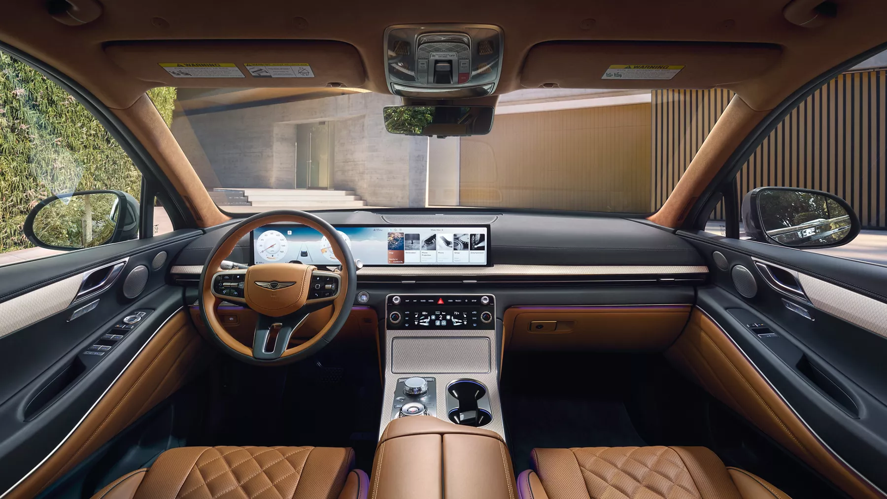 Interior view from back seats of Genesis GV80 cockpit and dashboard, vehicle parked at modern home