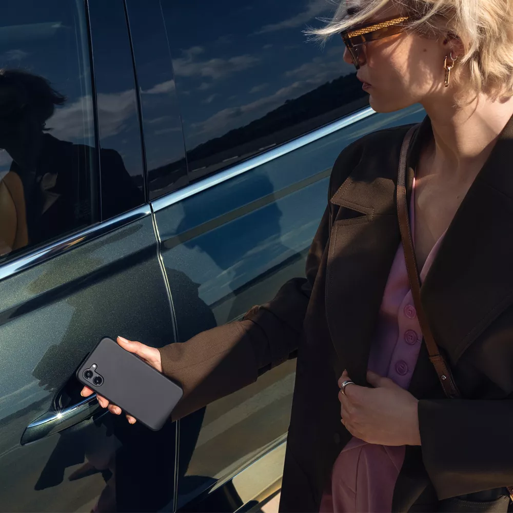 Close up exterior shot of person holding smartphone Digital Key up to Genesis GV80 driver side door