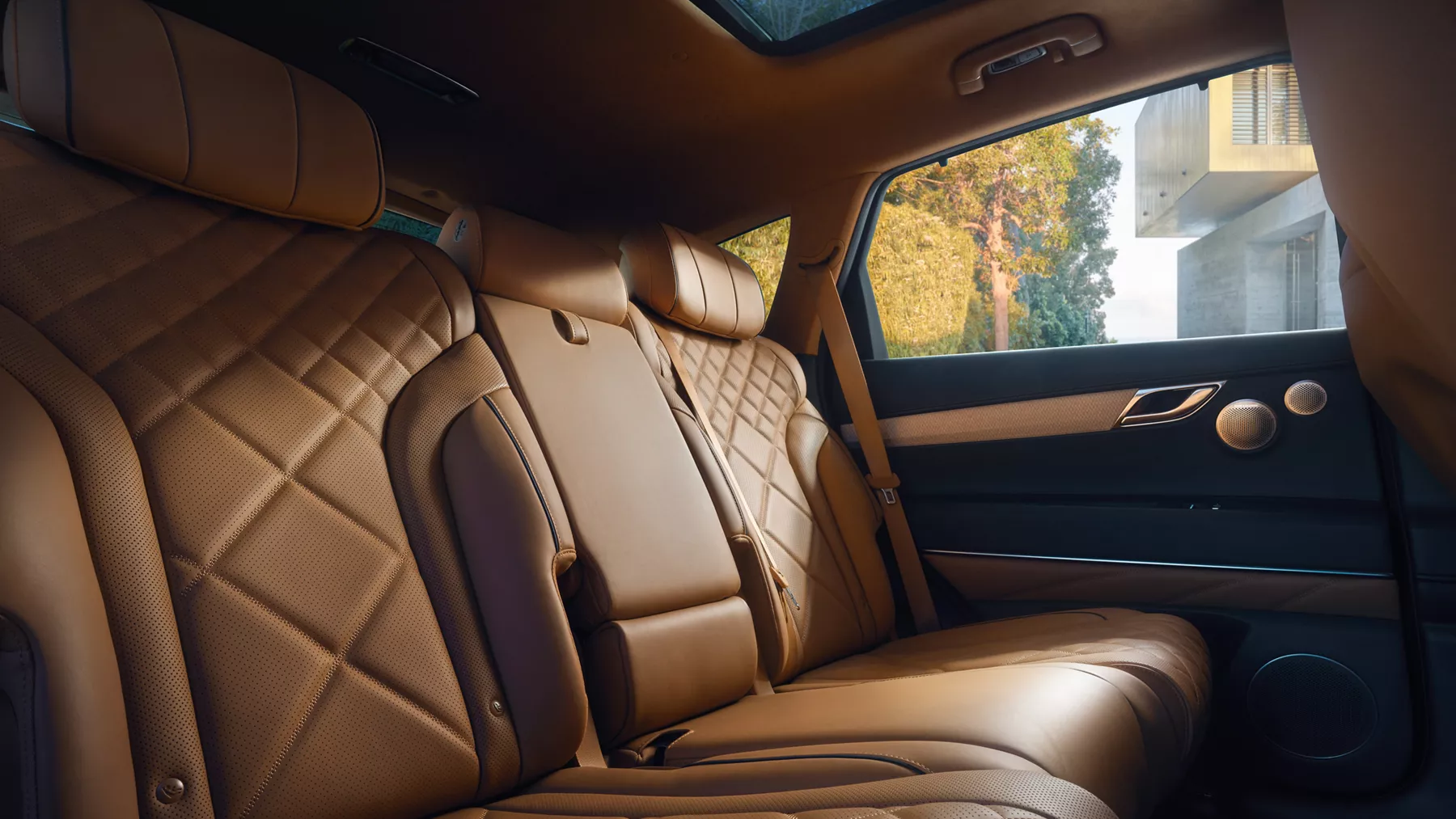 Interior close up of Genesis GV80's rear quilted Nappa leather seats in Dune tan