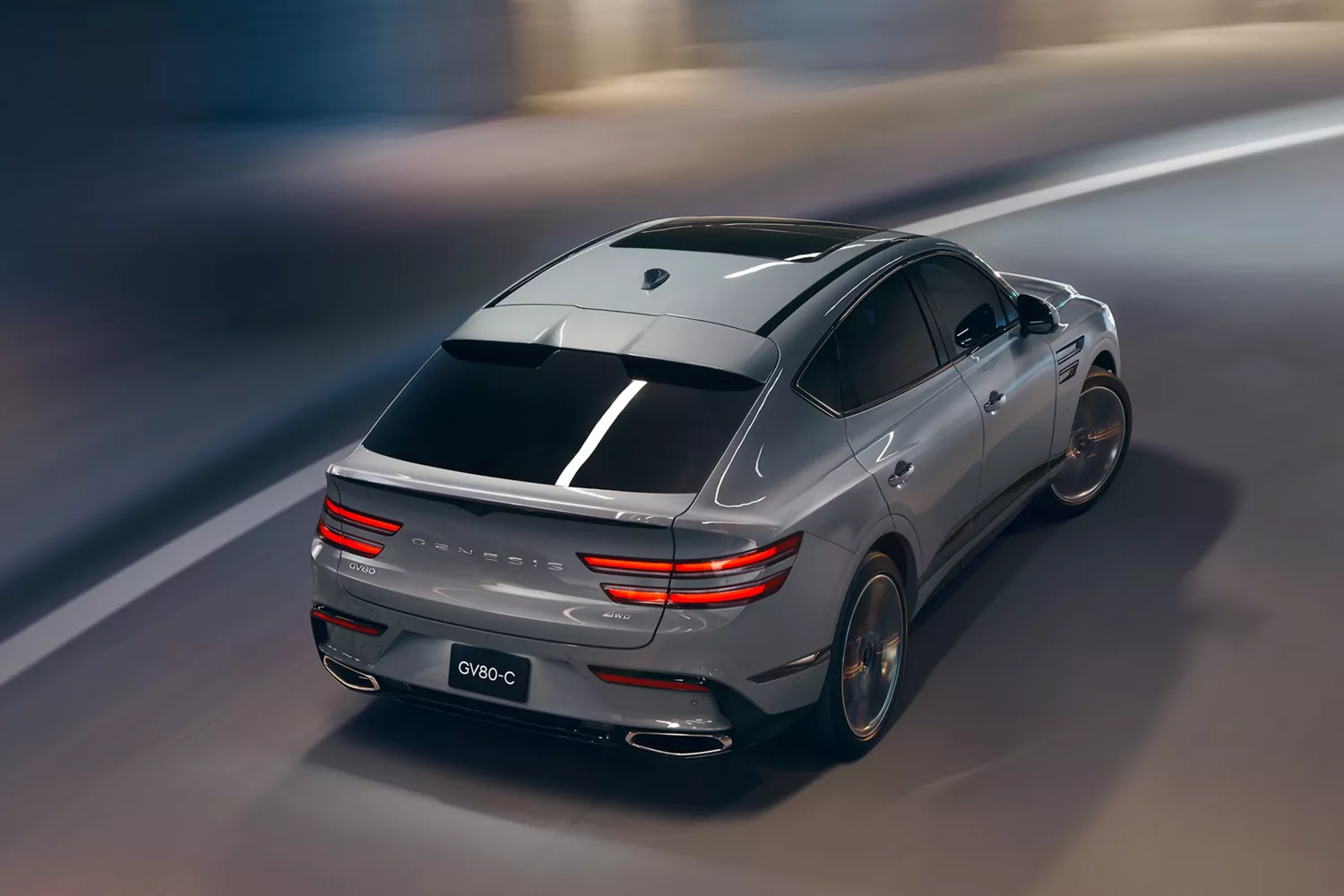Rear overhead view of Genesis GV80 Coupe in Bering Blue driving through a parking structure