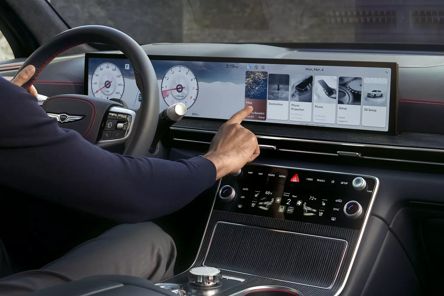 Interior view of driver touching the Navigation Integrated display inside the Genesis GV80 Coupe