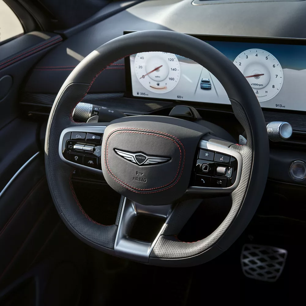 Close up of Ultramarine Blue D-Cut steering wheel inside the Genesis GV80 Coupe