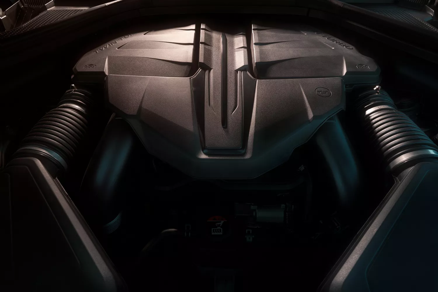 Closeup of Genesis GV80 Coupe Prestige Black engine bay, engine cover and surrounding components