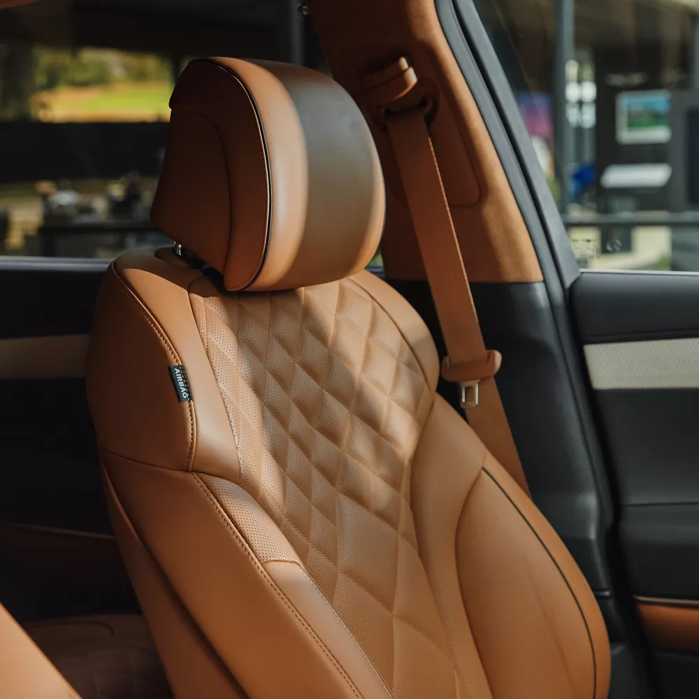 Front seat close-up of beige Nappa leather interior inside Genesis GV80