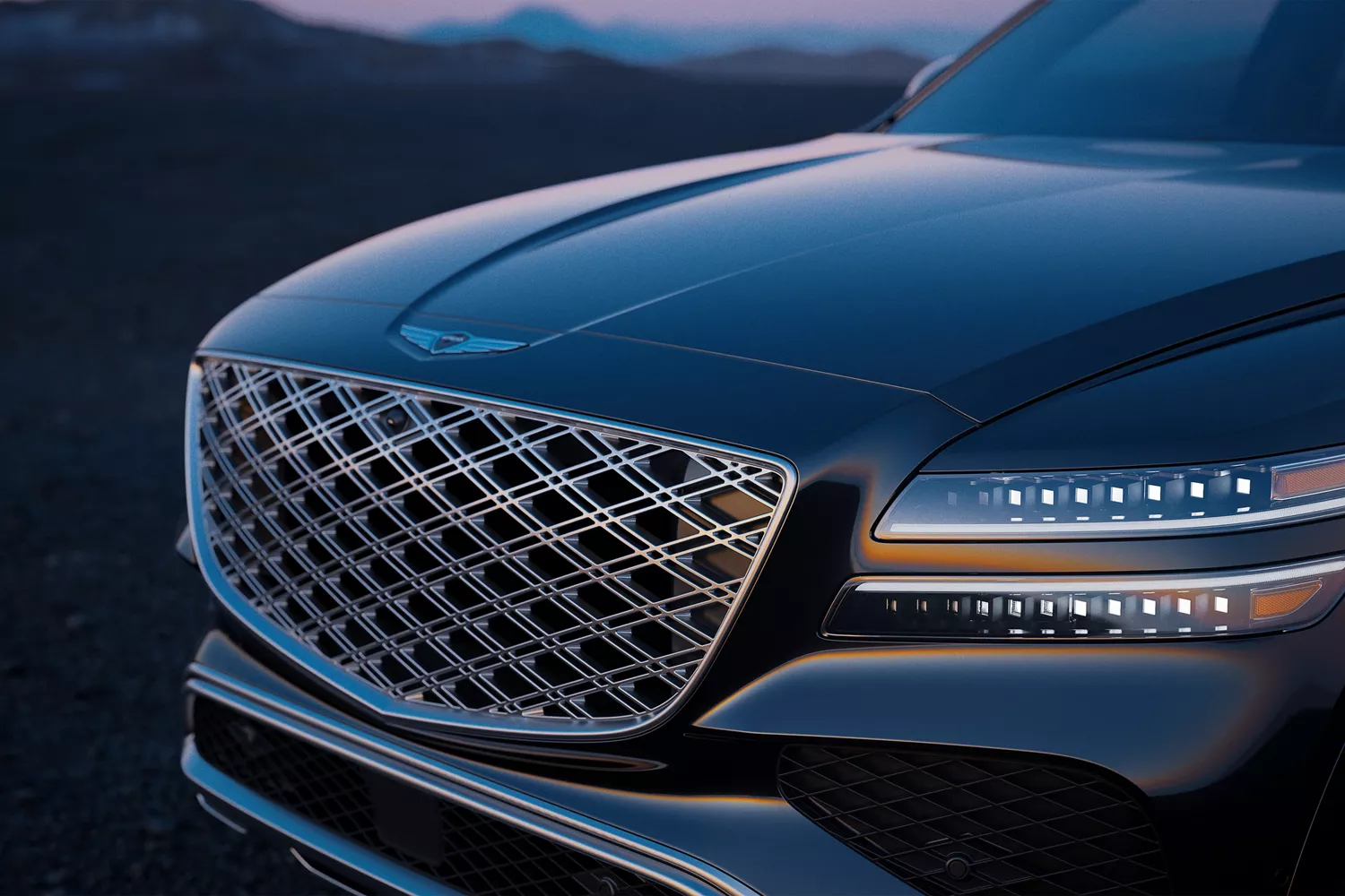 Front 3/4 driver side close-up of Genesis GV80 grille and LED headlights