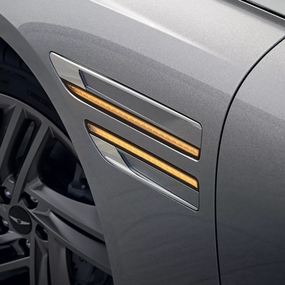 Close up of Genesis G80 fender with turn signal illuminated