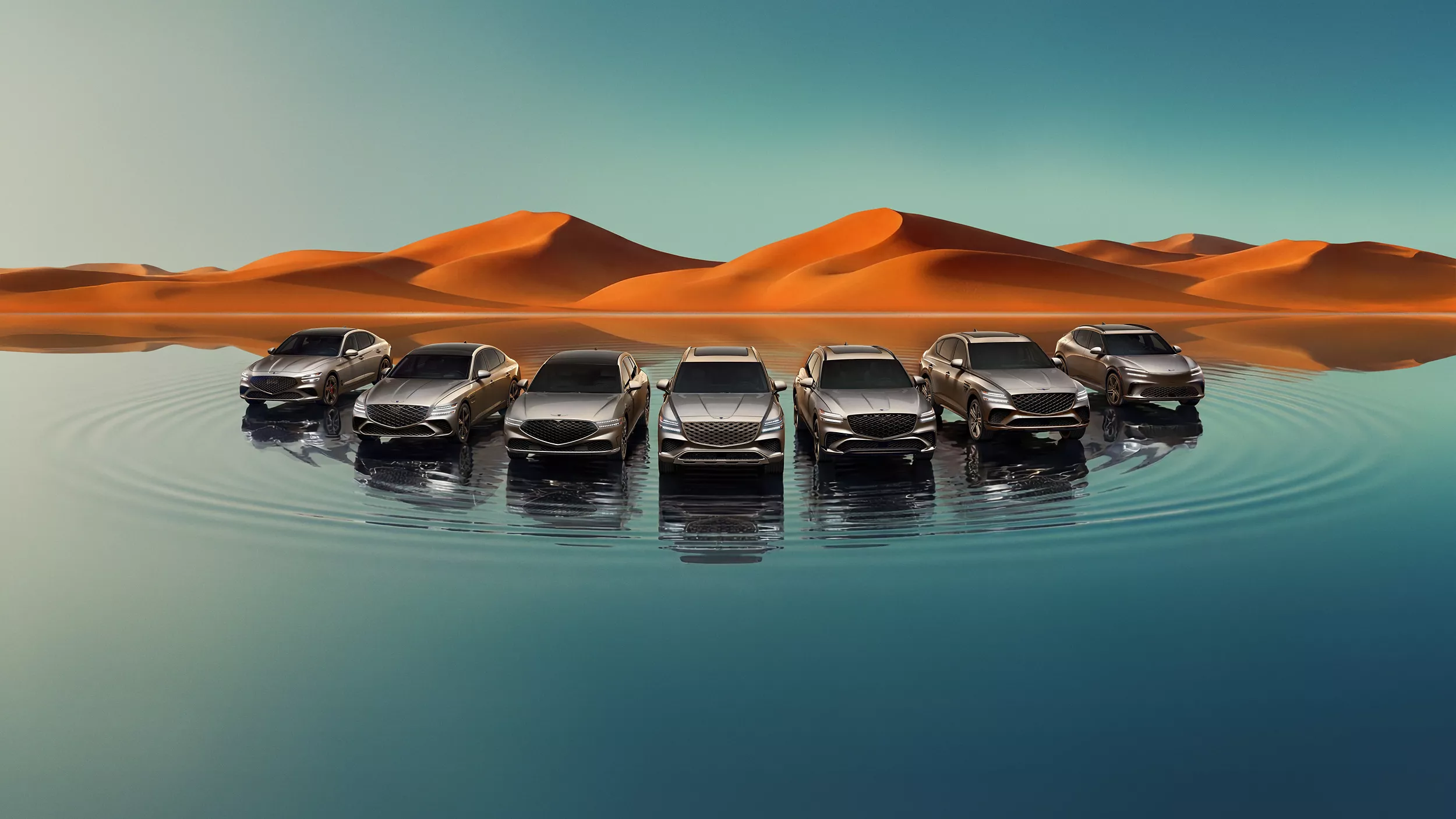 Front angle of Genesis lineup; G70, G80, G90, GV60, GV70, GV80, and GV80 Coupe on a reflective lake with mountains in background