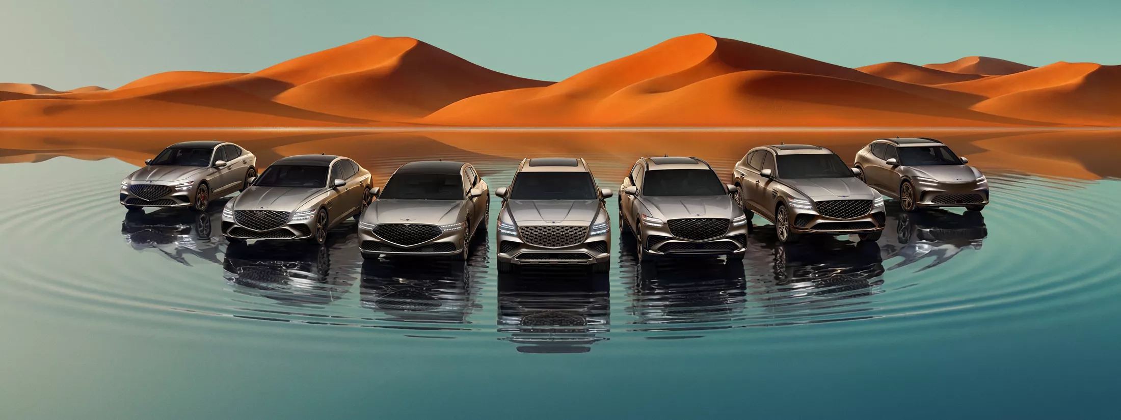 Front angle of Genesis lineup; G70, G80, G90, GV60, GV70, GV80, and GV80 Coupe on a reflective lake with mountains in background