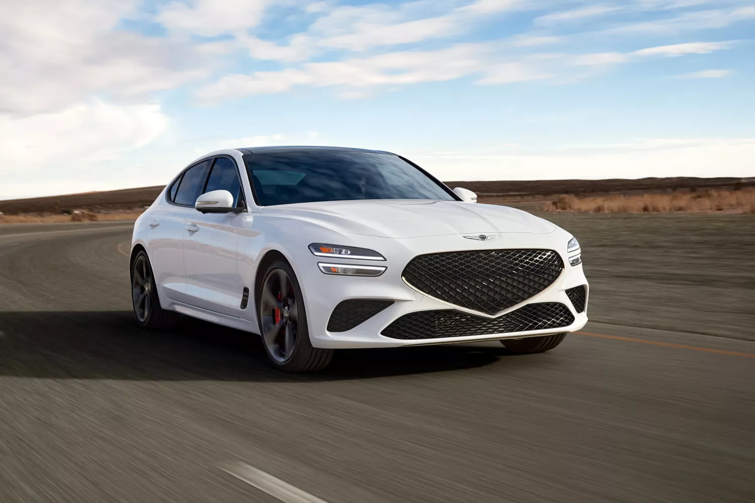 "Handling & Responsiveness" component with close up of Genesis G70 in Alta White on empty highway