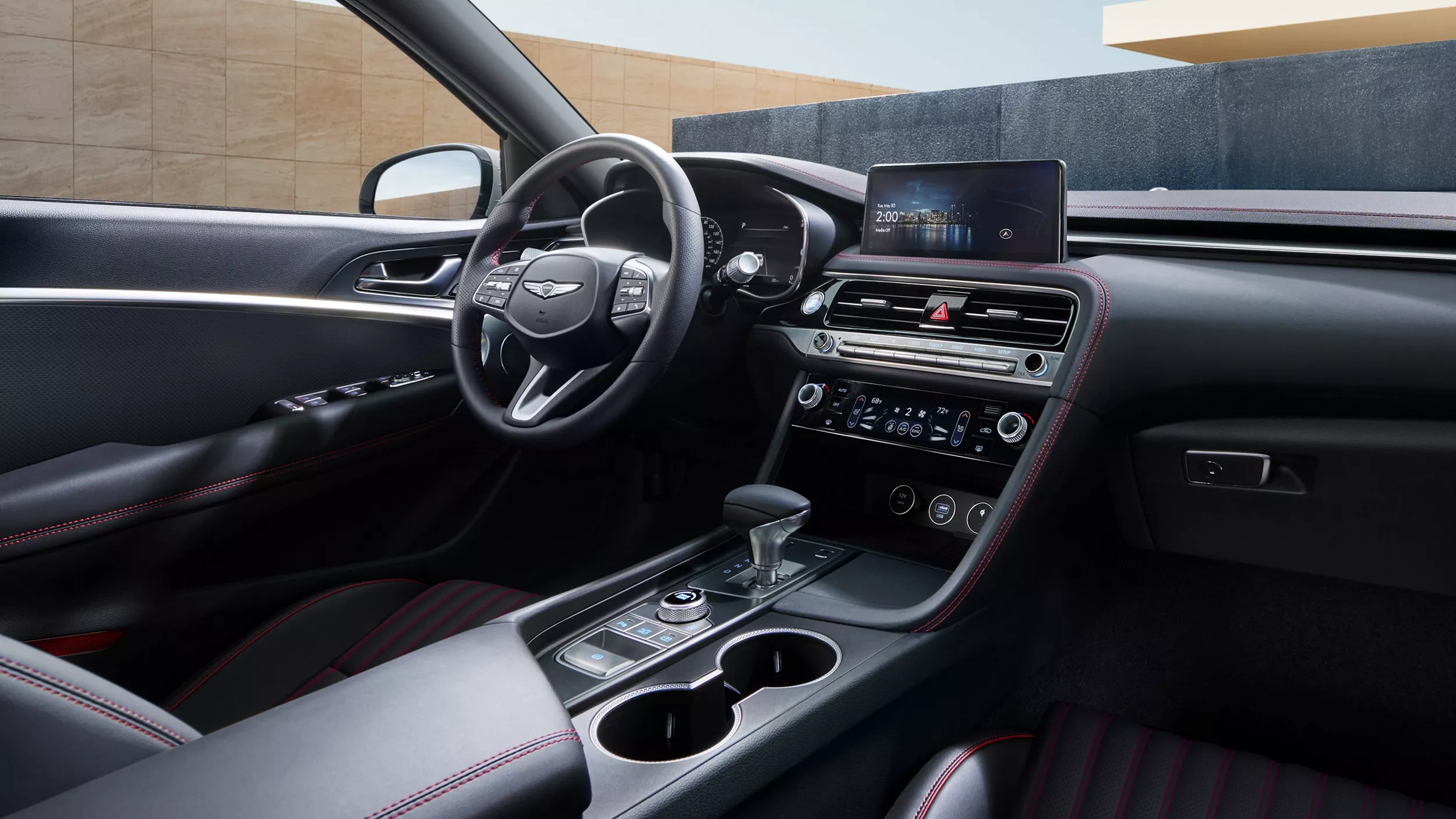 Interior passenger pov of 2026 Genesis G70, steering wheel, center console and infotainment in focus