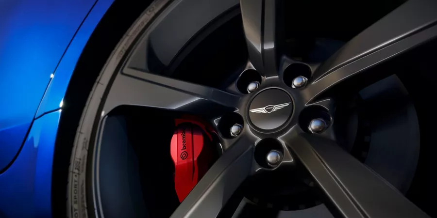 "Design Details" component with close up of wheel detail on Genesis G70 in Kawah Blue