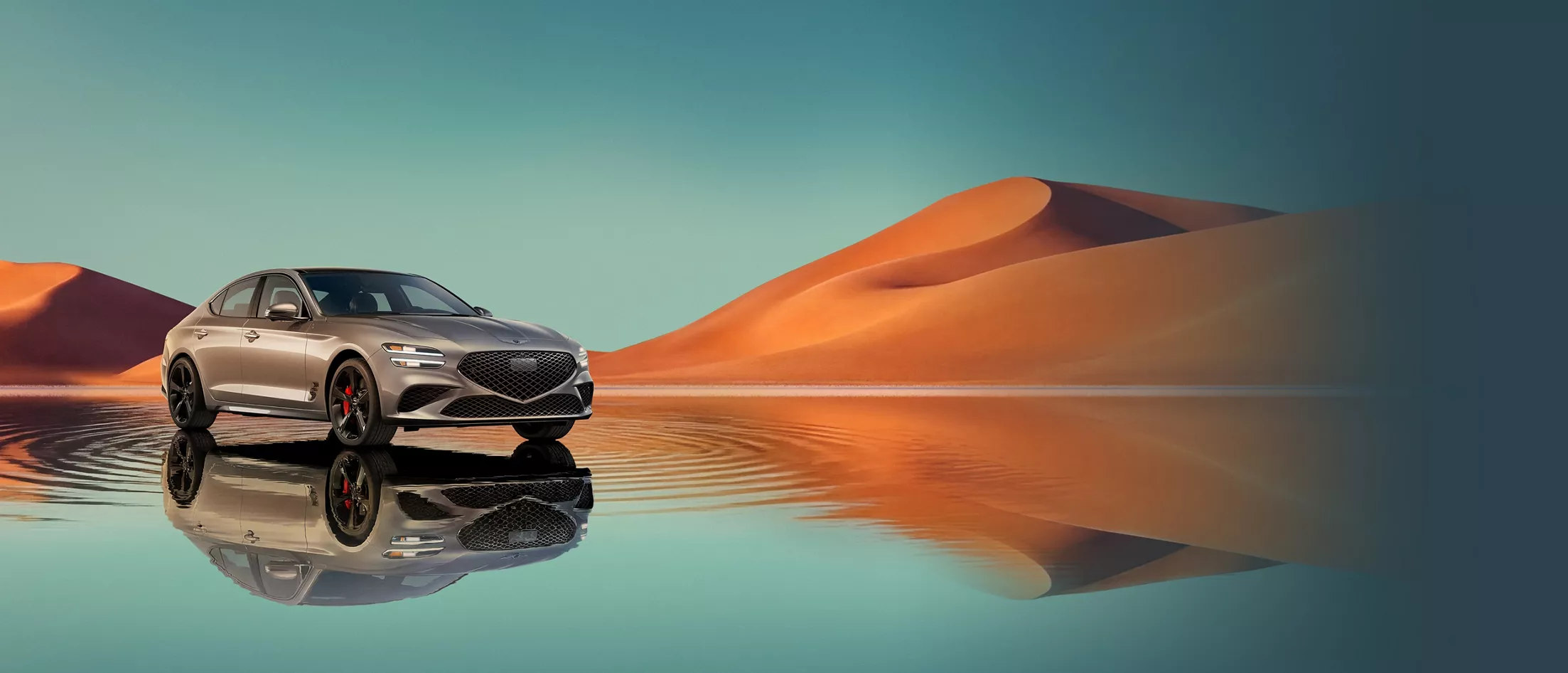 7/8 front passenger view of Savile Silver Genesis G70 on blue lake w/ orange mountain in background