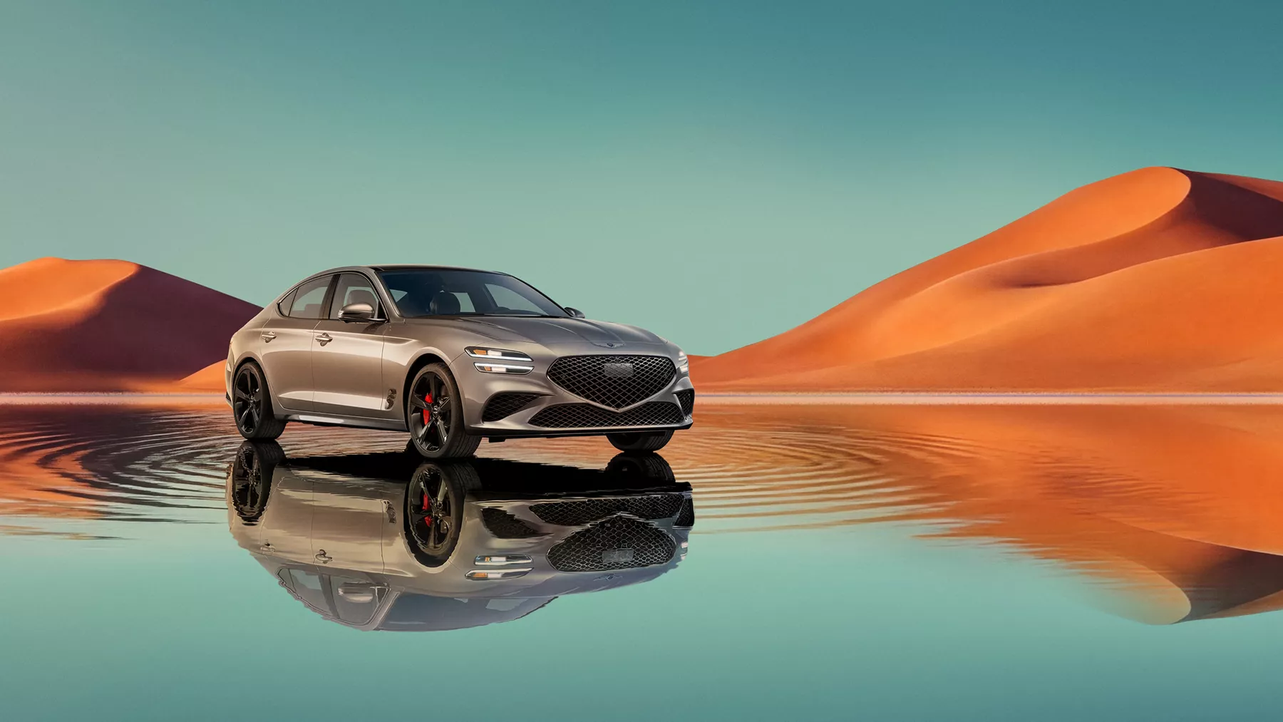 7/8 front passenger view of Savile Silver Genesis G70 on blue lake w/ orange mountain in background