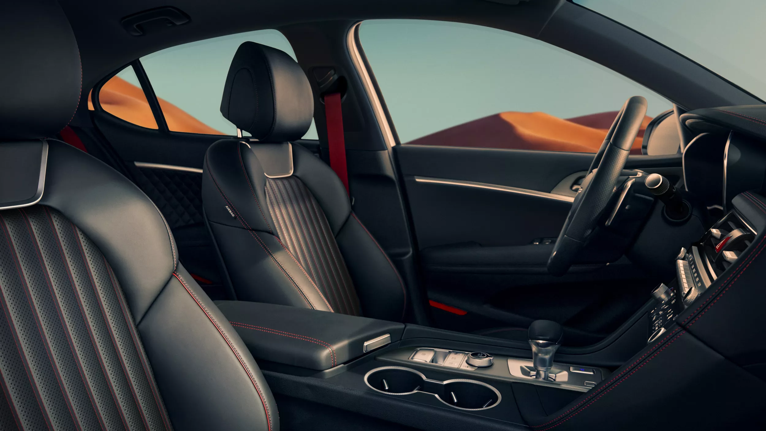 Interior front passenger seat pov inside Genesis G70 with blue sky and mountains in background