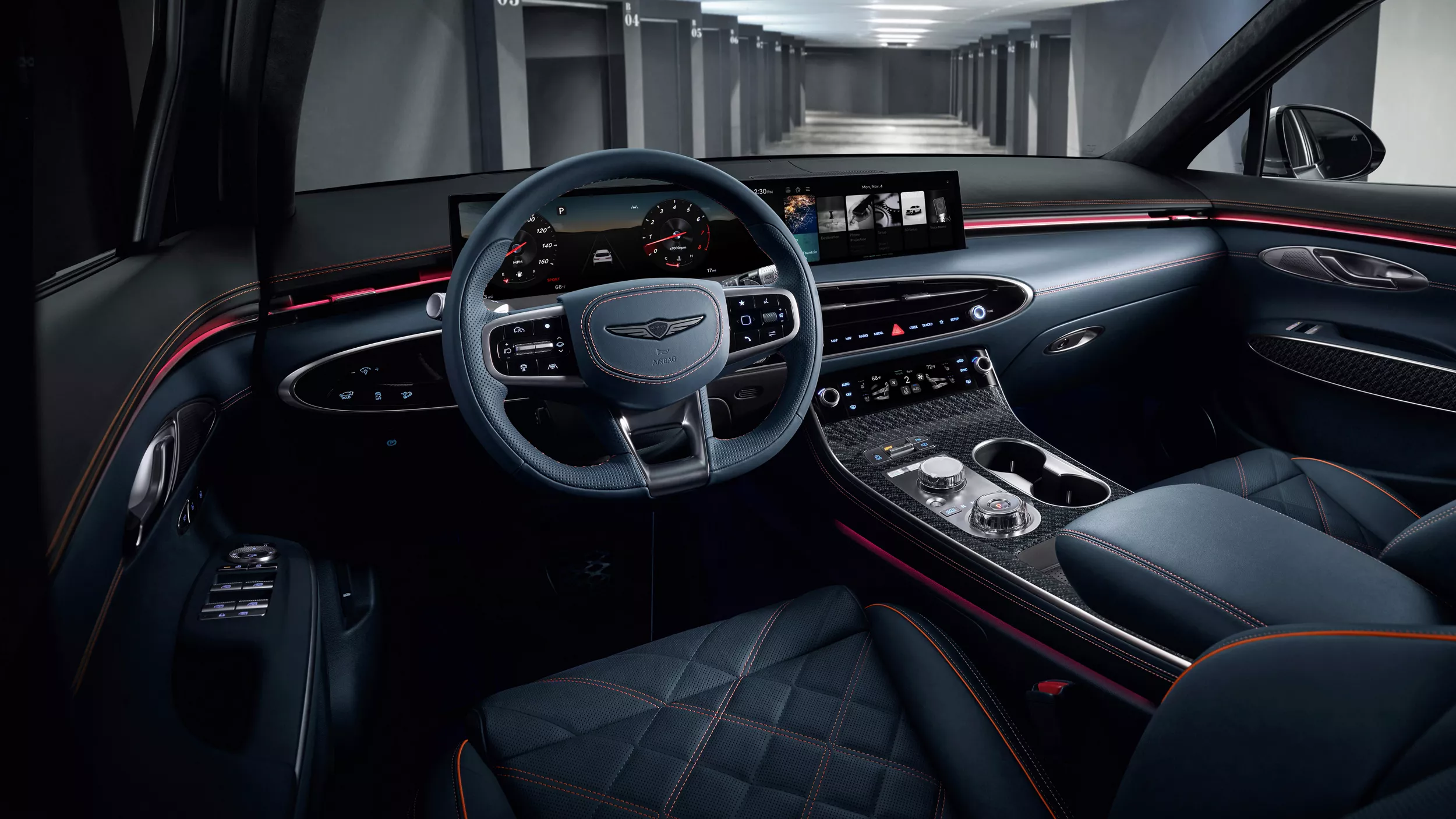 Genesis GV70 interior driver’s view of steering wheel, quilted seats, dashboard, and digital display