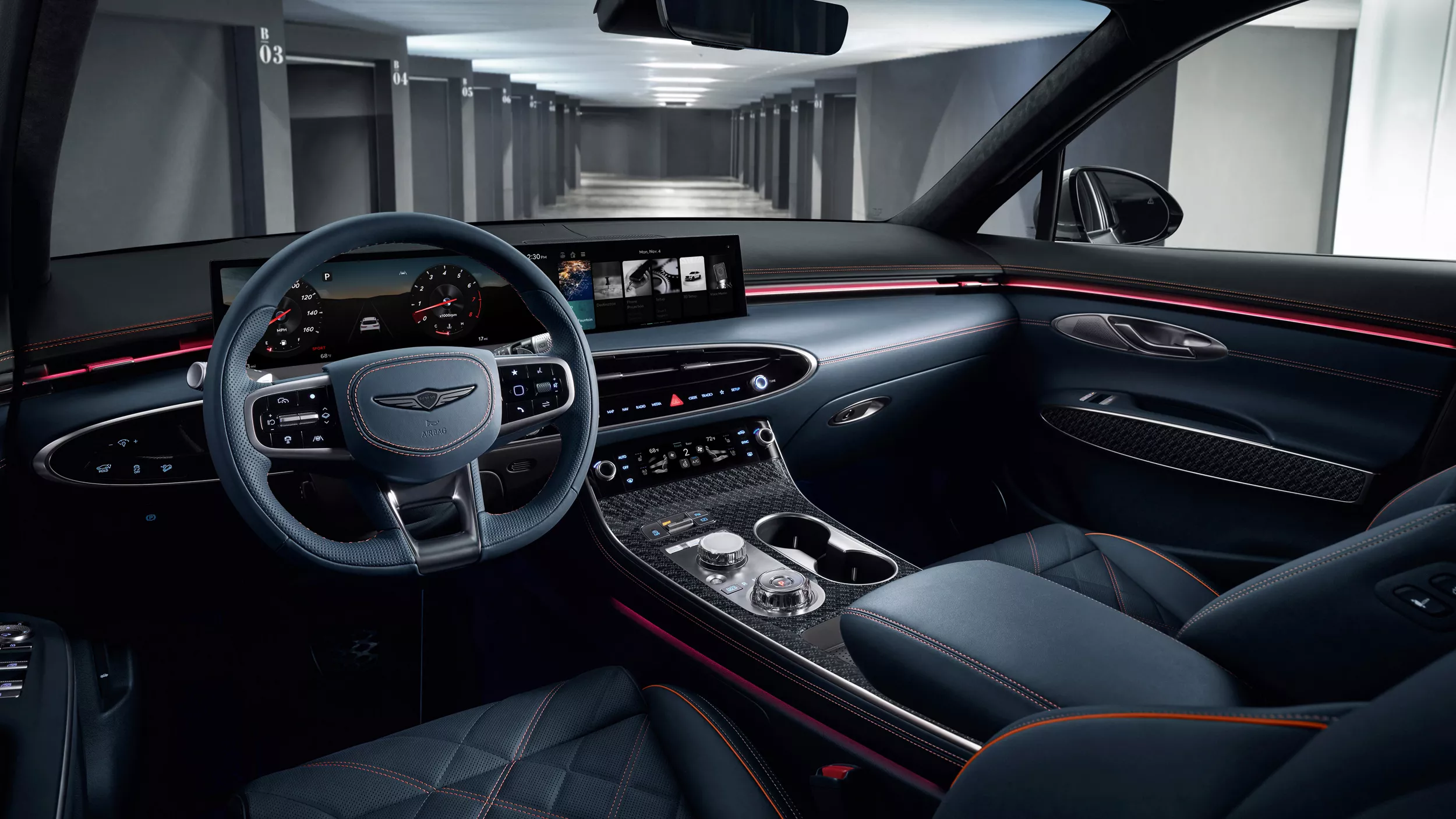 Genesis GV70 interior driver’s view of steering wheel, quilted seats, dashboard, and digital display