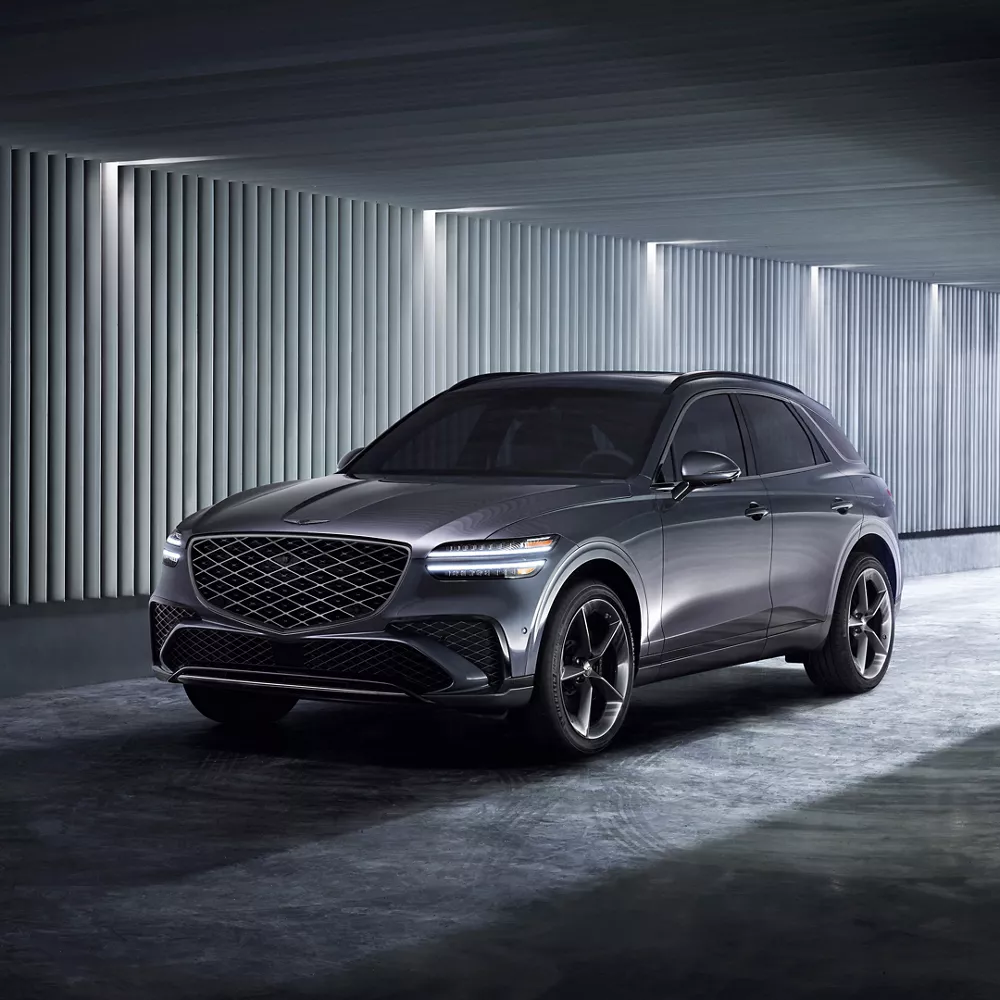 Dark gray Genesis GV70 parked in a garage