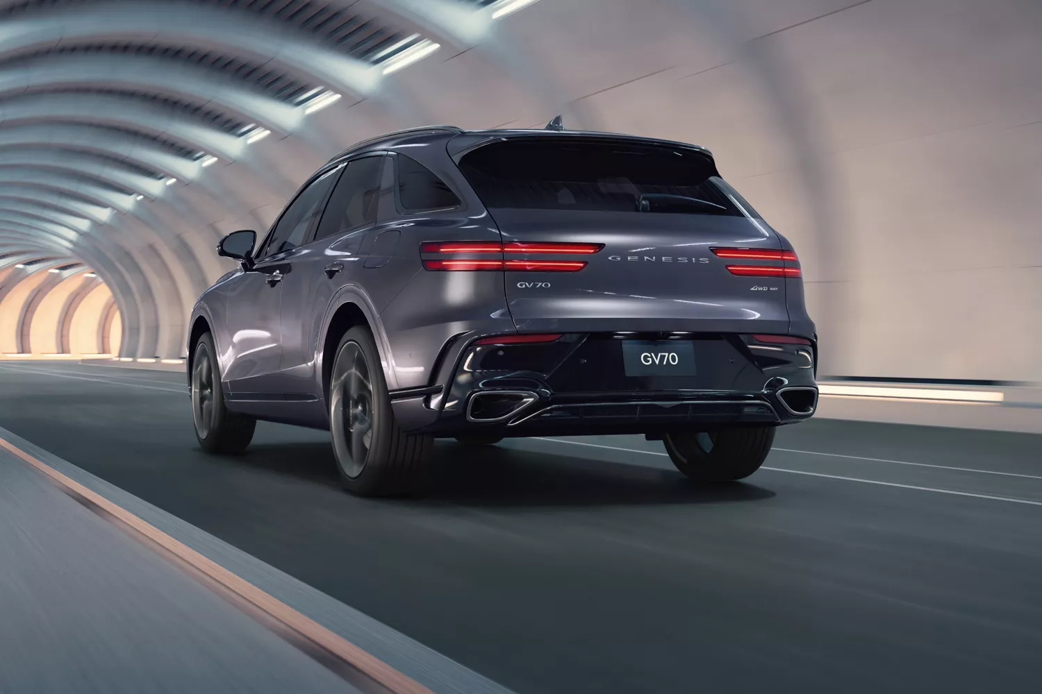 3/4 rear driver side view of Genesis GV70 driving through tunnel