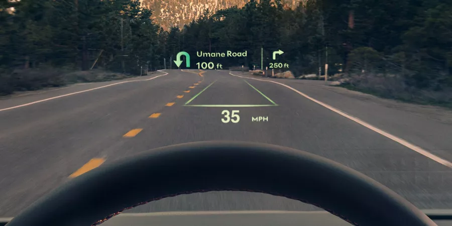 Driver POV of 2026 Genesis GV70 head-up display showing turn-by-turn navigation and speed details