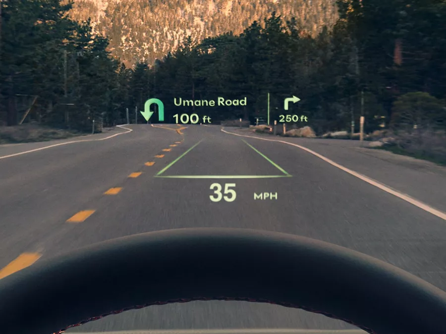 Driver POV of Genesis GV70 head-up display showing turn-by-turn navigation and speed details