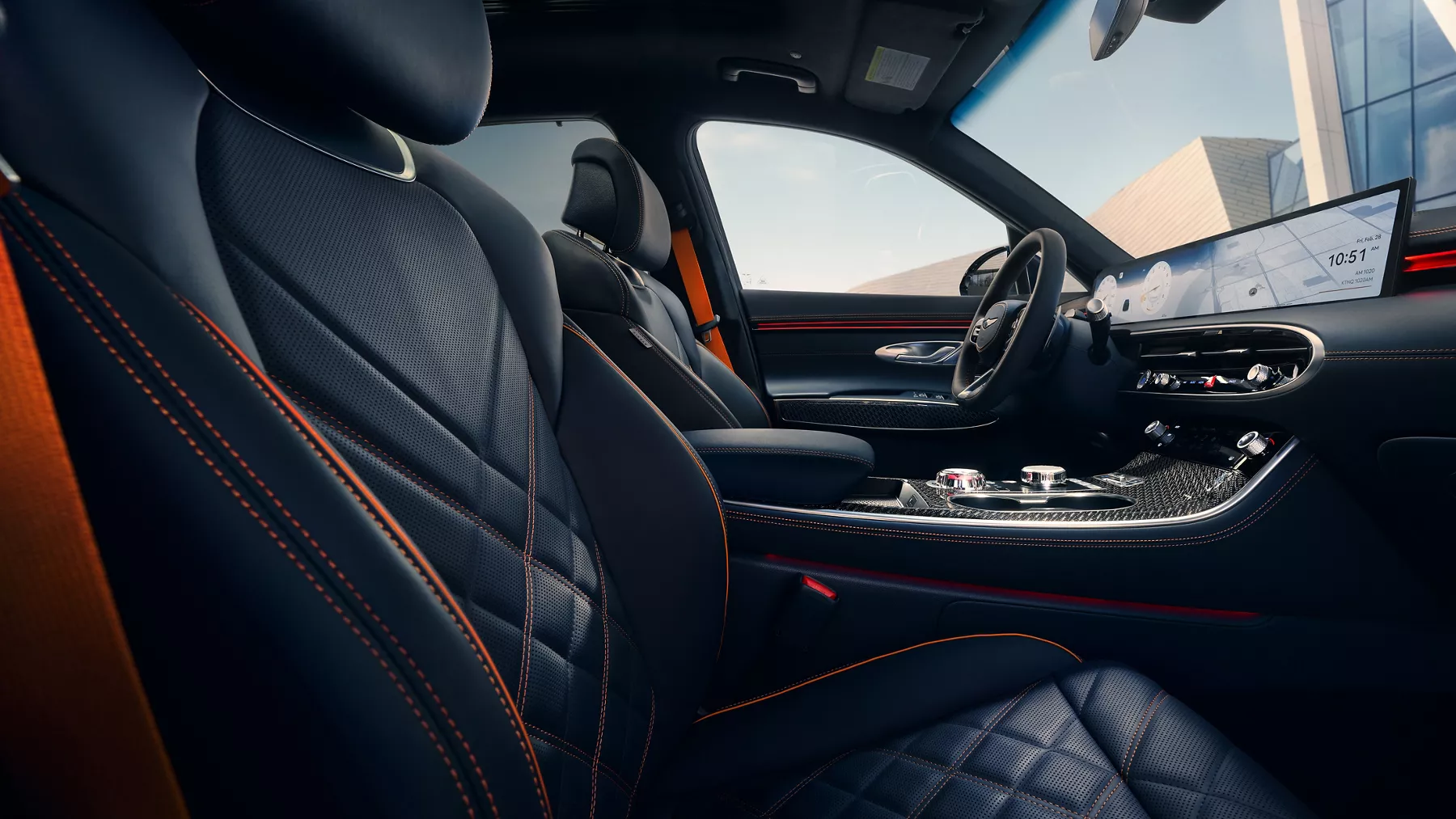 Passenger-to-driver POV of 2026 Genesis GV70 interior in Obsidian Black & Ultra-Marine Blue details