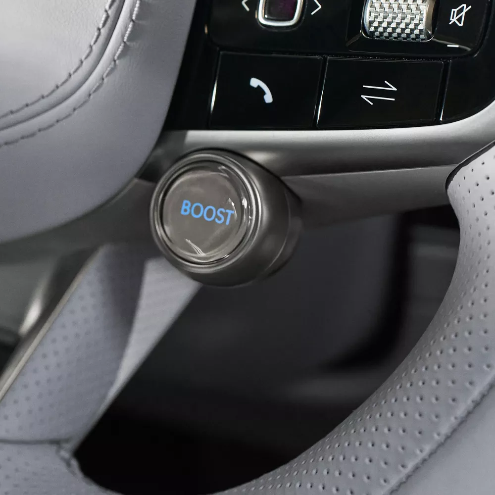 Interior closeup of Boost mode button on steering wheel inside Genesis Electrified GV70
