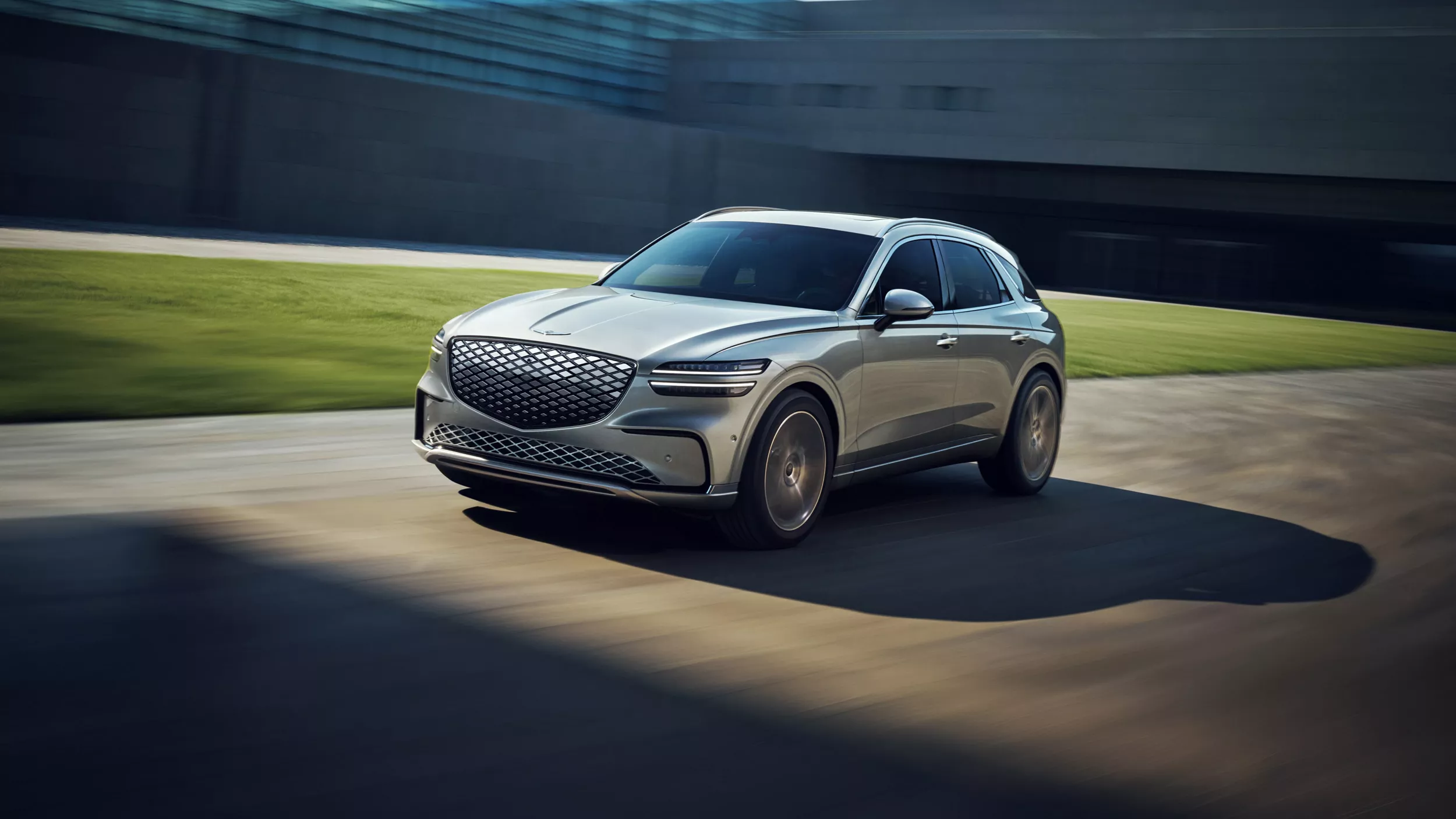3/4 front driver side view of Genesis Electrified GV70 in motion