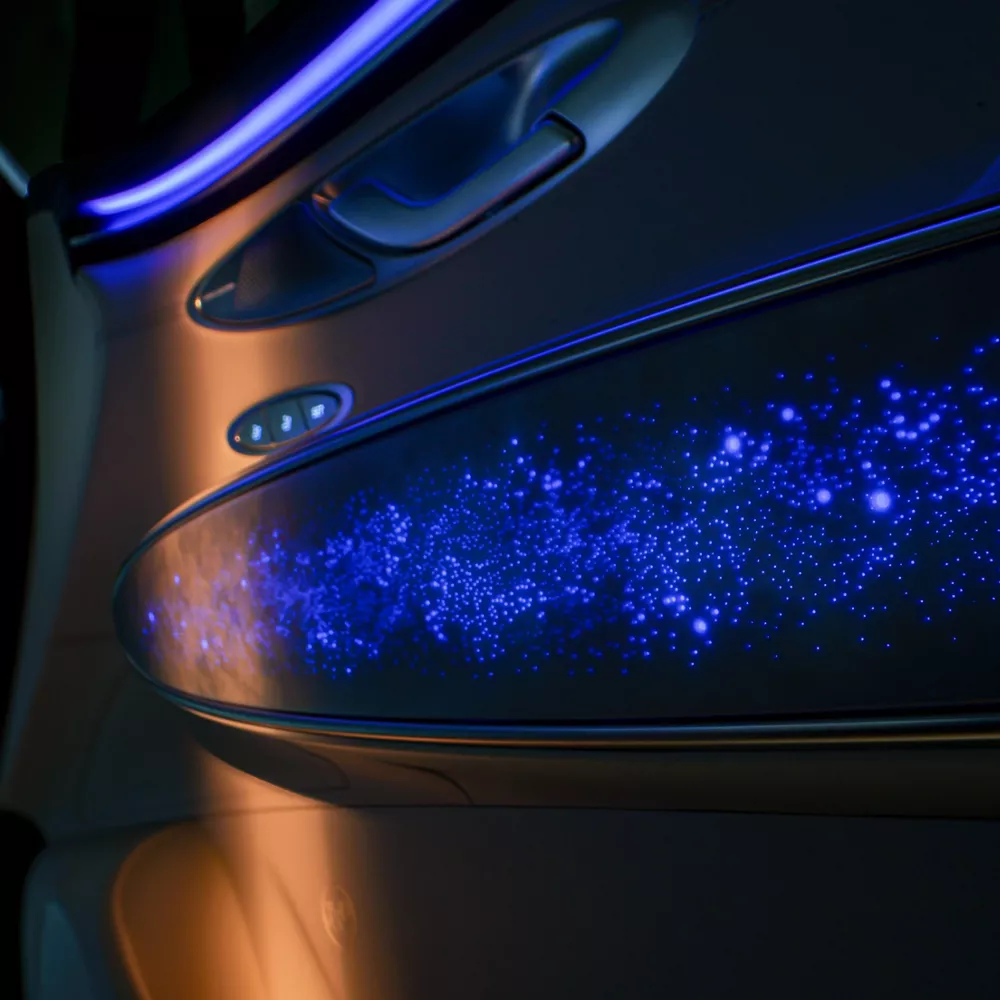 interior close-up of ambient blue lighting and door handle inside Genesis Electrified GV70