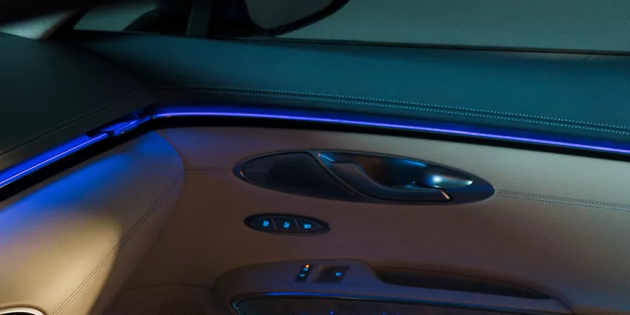 Close up of blue ambient mood lighting on passenger side door panel of Genesis Electrified GV70