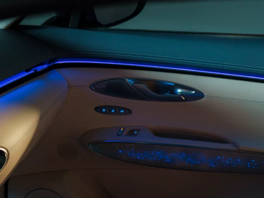Close up of blue ambient mood lighting on passenger side door panel of Genesis Electrified GV70